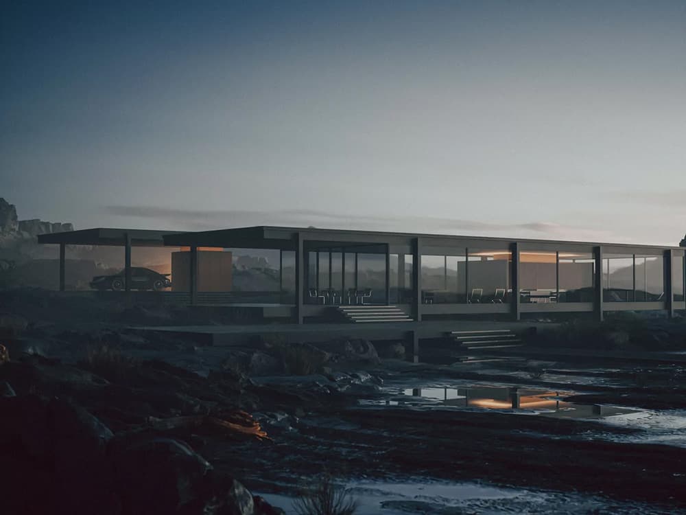 a building is seen at dusk by the water shore and a few cars are parked at the front